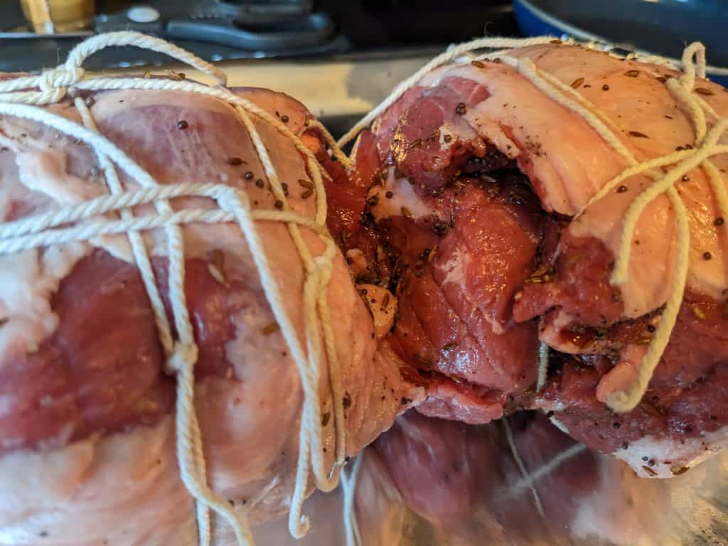 Rolled and tied leg of lamb rubbed with herbs, not yet cooked