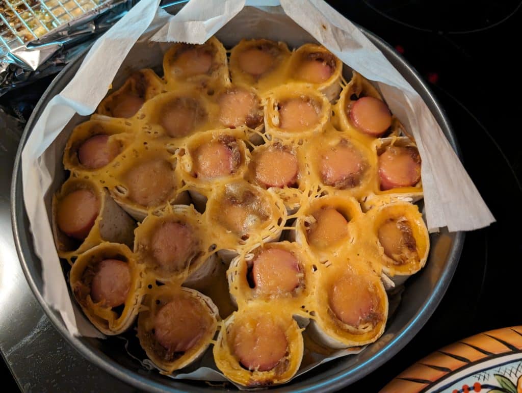 Baked Hot Dog Roll-ups in a parchment paper lined springform pan