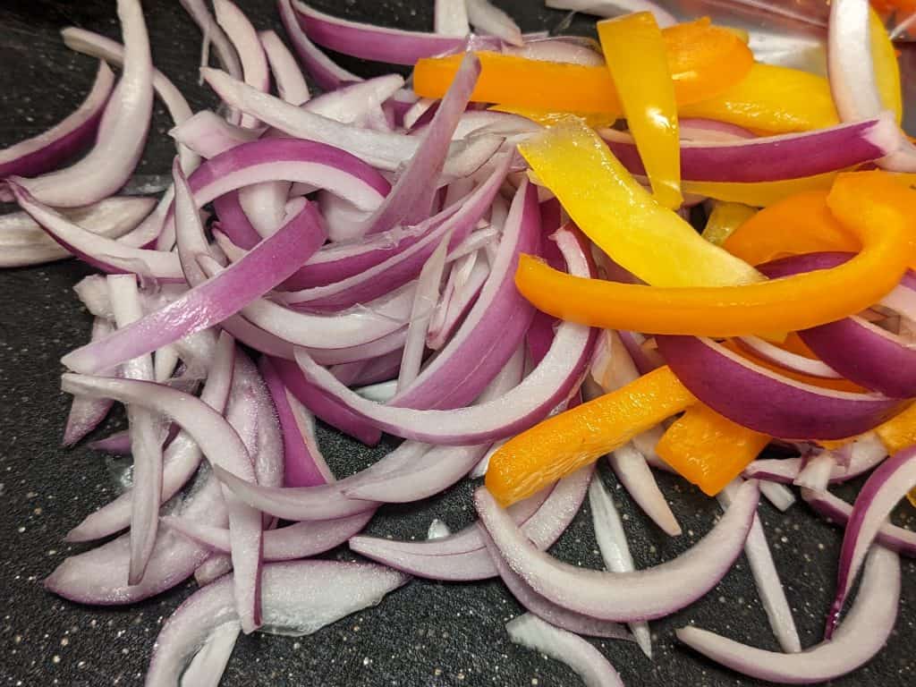 Sliced red onions and bell peppers