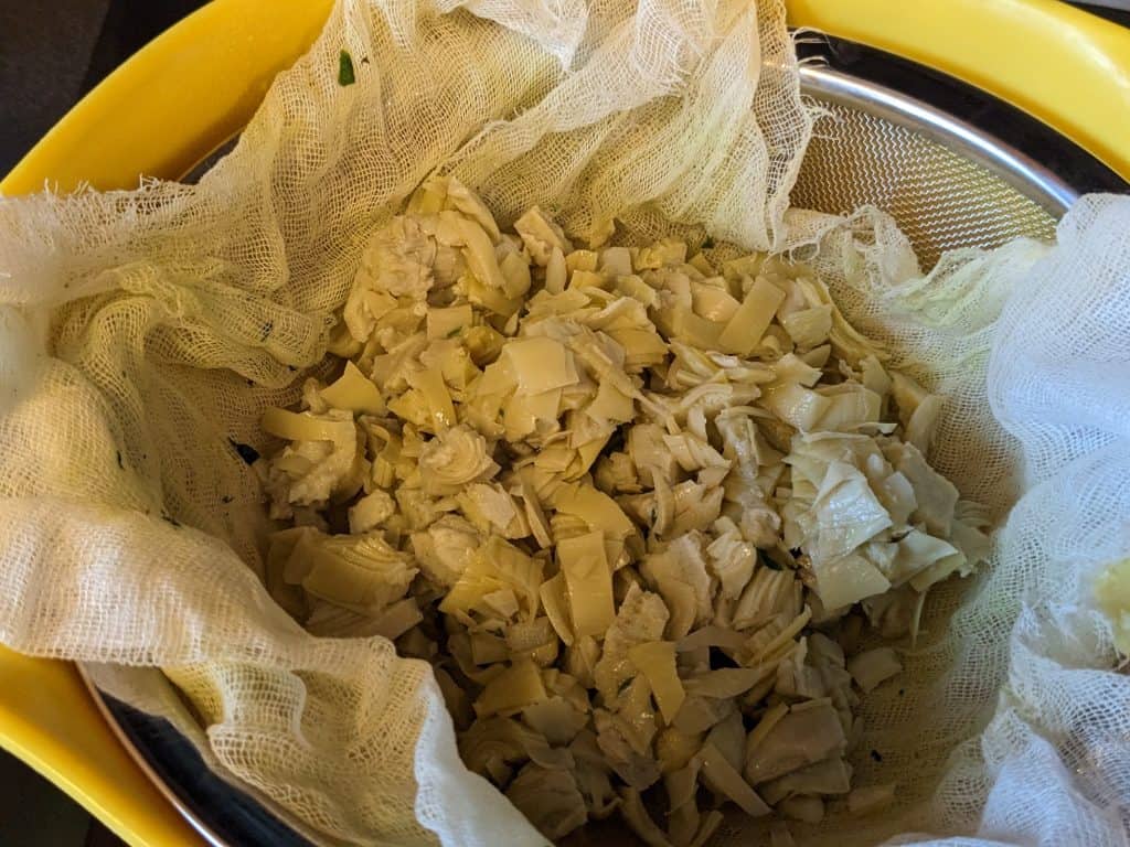 Chopped Artichoke Hearts in cheesecloth not yet strained