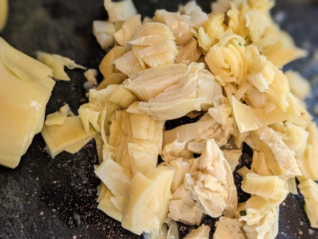 Artichoke hearts in the process of being chopped