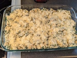 Keto Spinach and Artichoke Casserole - Unbaked in Casserole Dish with Parmesan Topping