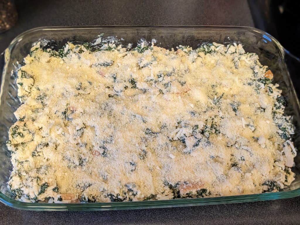 Uncooked Keto Spinach and Artichoke Casserole in baking dish