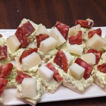 Soppressata and Manchego Pesto Canapes on plate