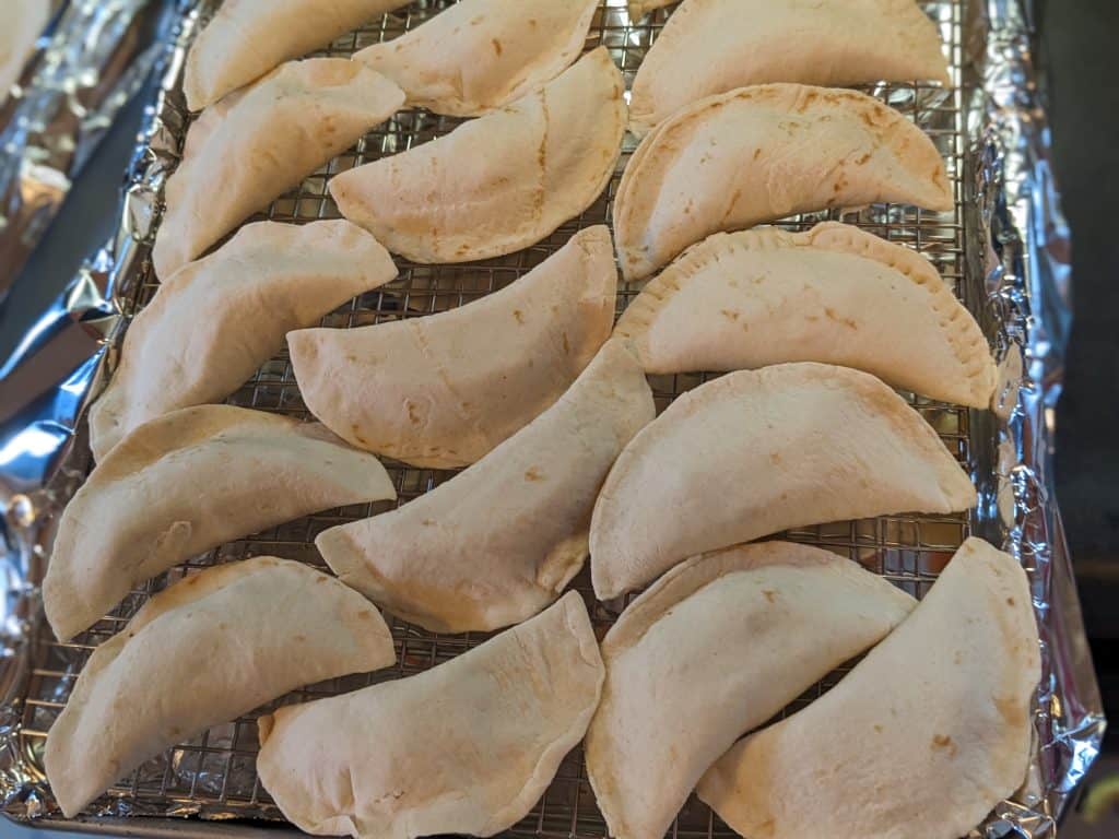 Turkey empanadas on baking sheet ready for oven