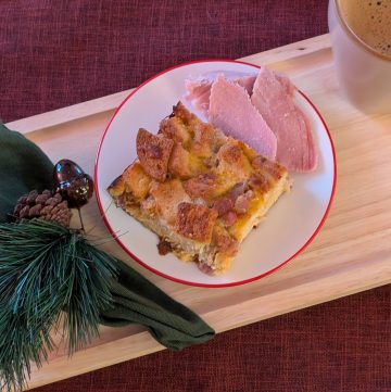 Ham and Cheese Breakfast Strata on a plate with a holiday napkin