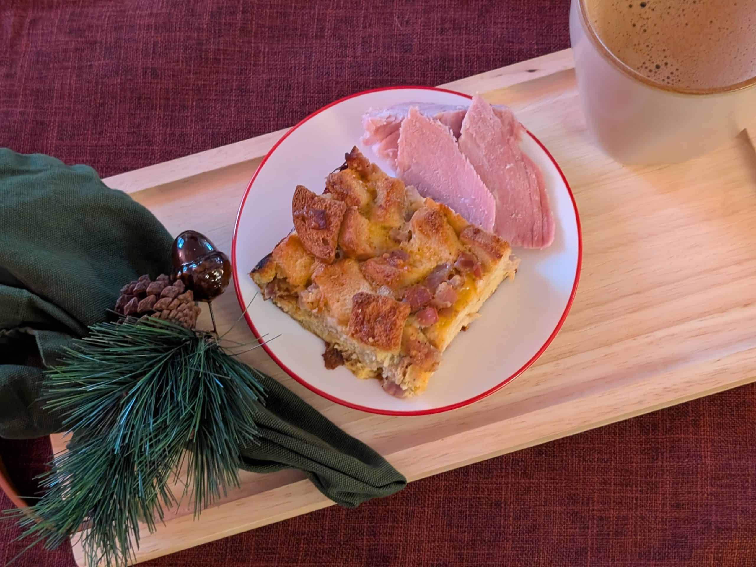 Ham and Cheese Breakfast Strata on a plate with a holiday napkin