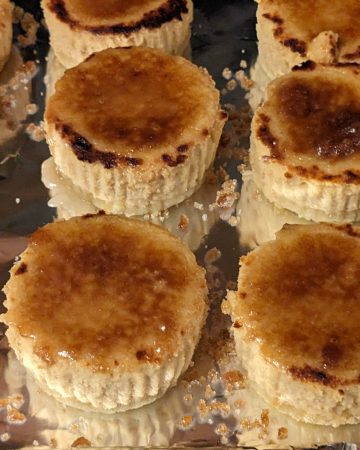 Irish Cream Creme Brulee Mini Cheesecakes on a sheet pan