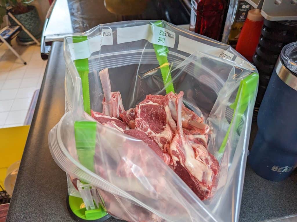 Raw lamb chops cut and in zip top bag