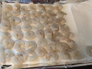 Raw shrimp drying on paper towels