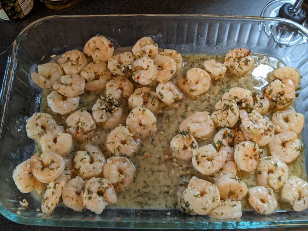 Cooked shrimp scampi cooling in a large casserole dish