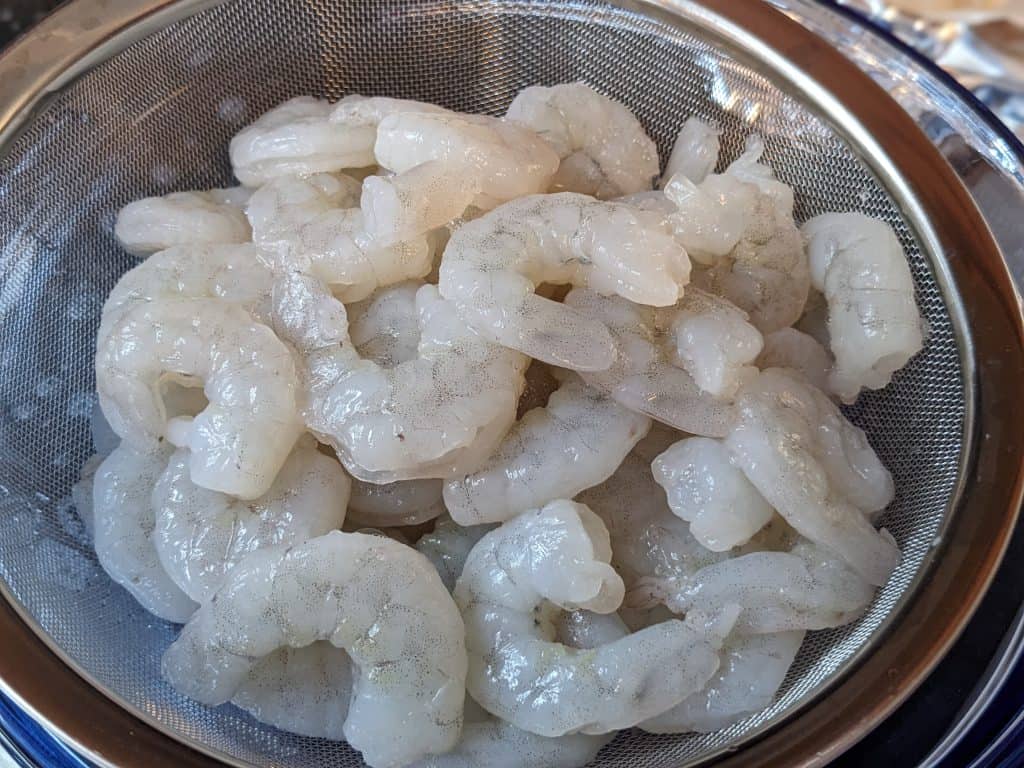 Raw shrimp in a strainer