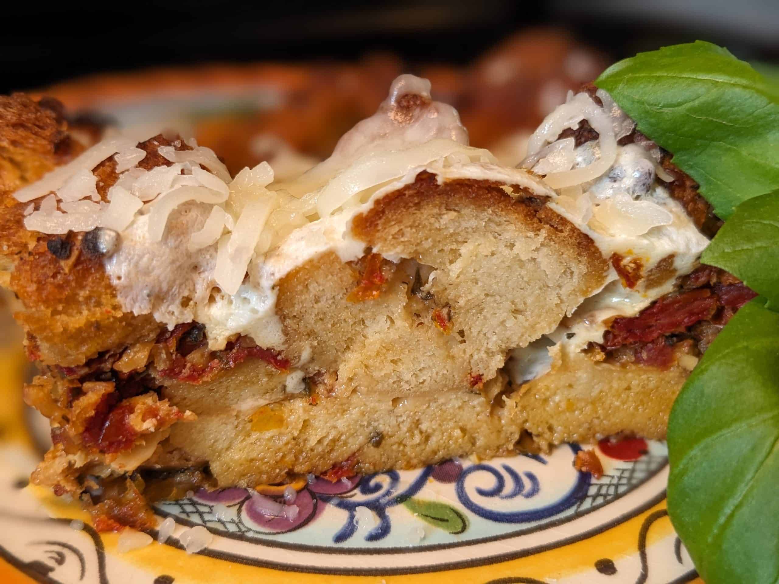 Keto Caprese Stuffing Casserole on plate with fresh basil leaves