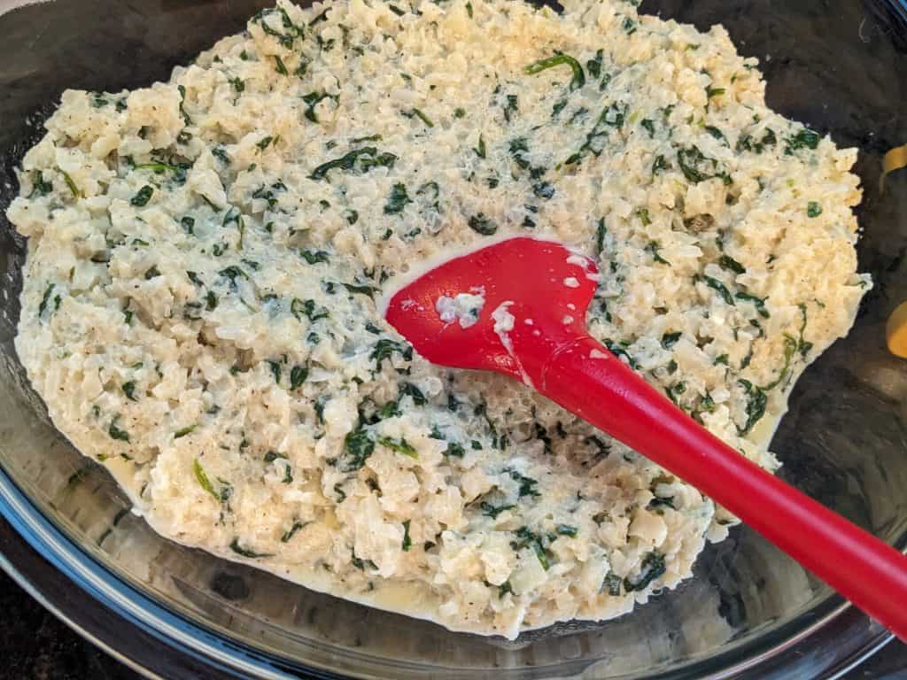 3 Cheese and Spinach Cauliflower Rice in a glass mixing bowl