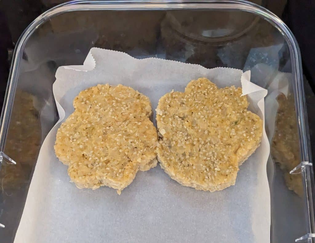 Cheddar Creole Cauliflower Chia Cakes in a plastic container