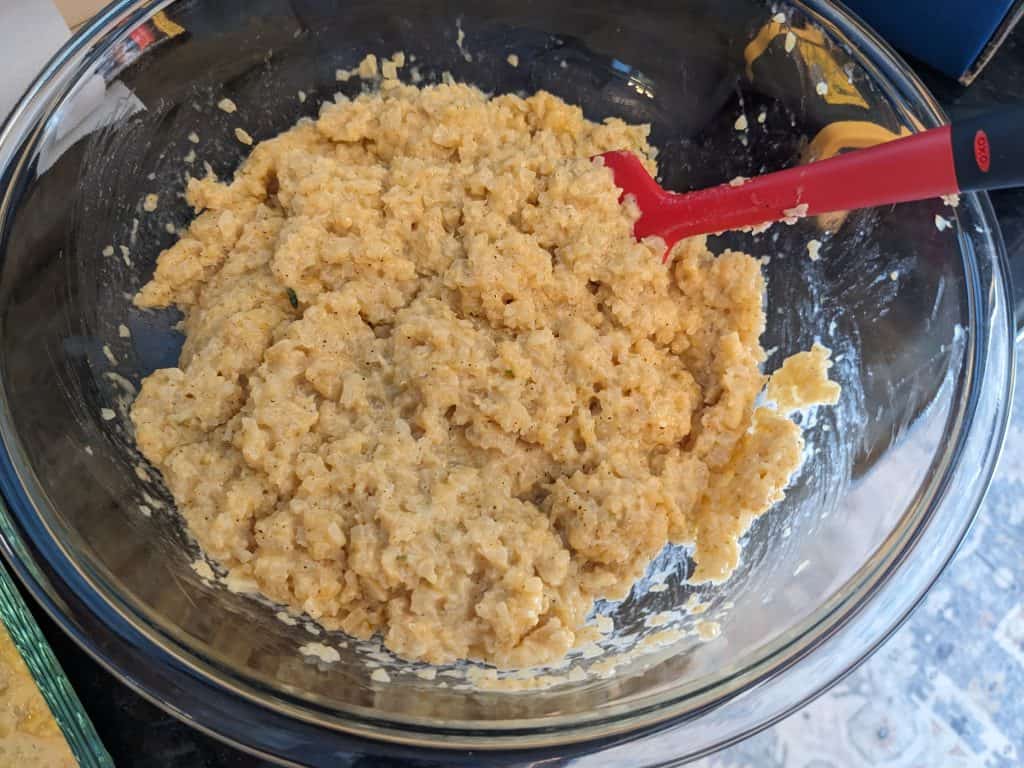 Cheddar Creole Cauliflower Rice in a glass mixing bowl