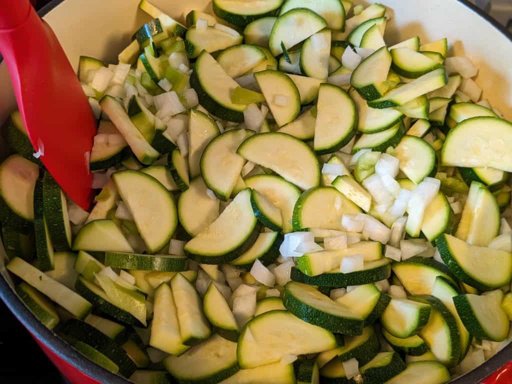 Raw zucchini, onion, and cubanelle peppers in pot