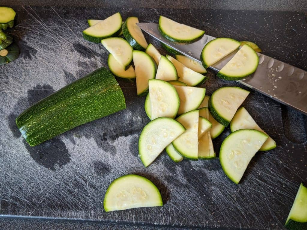 Slicing zucchini on a cutting board