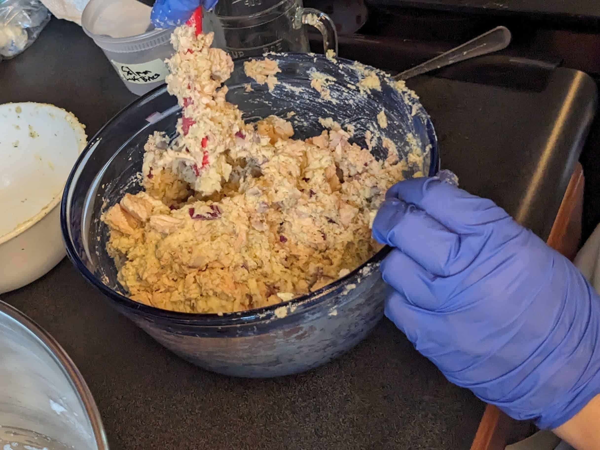 Folding egg whites into salmon batter close up