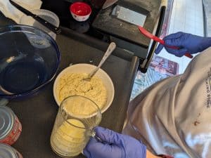 Mixing almond flour, baking powder, dried dill, salt, pepper, heavy cream, melted butter, and egg yolks in a small bowl