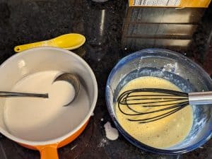 Tempering the eggs while combining cream and eggs for keto vanilla pudding