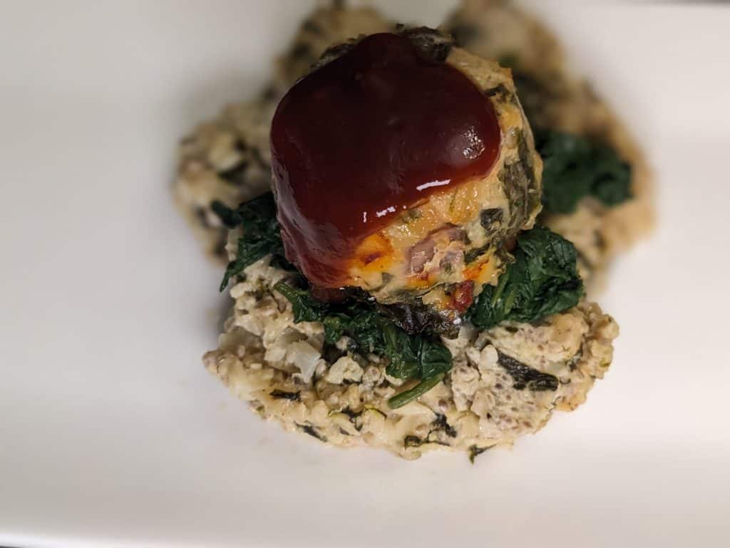 Mini Chicken Meatloaf on a 3 Cheese and Spinach Cauliflower Chia Cake with a Sweet Sriracha Sauce - plated