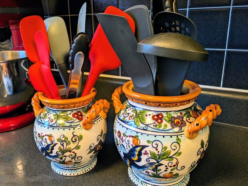 Two crocks filled with cooking utensils