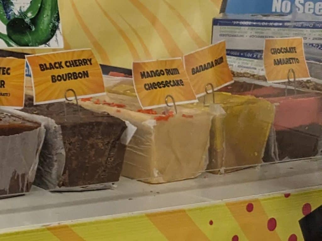 Four flavors of fudge in full blocks on a table--Black Cherry Bourbon, Mango Rum Cheesecake, Chocolate Amaretto