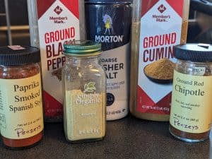 Spice ingredients for Bacon Cheddar Meatloaf--paprika, black pepper, dry mustard, salt, cumin, chipotle powder