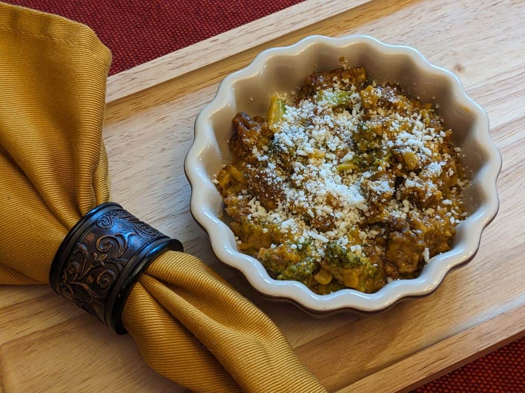 Broccoli Pumpkin Queso Casserole plated with napkin