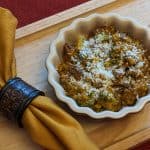 Broccoli Pumpkin Queso Casserole plated with napkin
