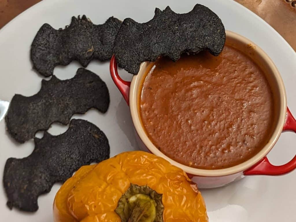 Keto Black Bat Crackers on plate with Roasted Tomato Poblano Soup and Stuffed Pepper