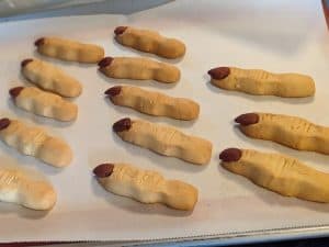 Keto Witch Finger Cookies baked but not yet decorated on a rimmed baking sheet