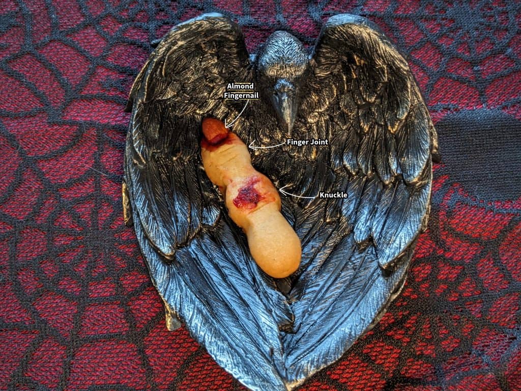 Keto Witch Finger Cookie in a Raven Dish with decorative elements labeled