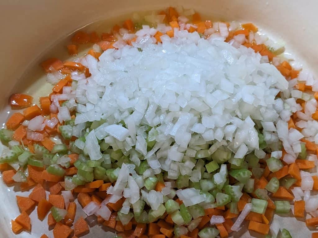 Onions, celery, and carrots in Dutch oven