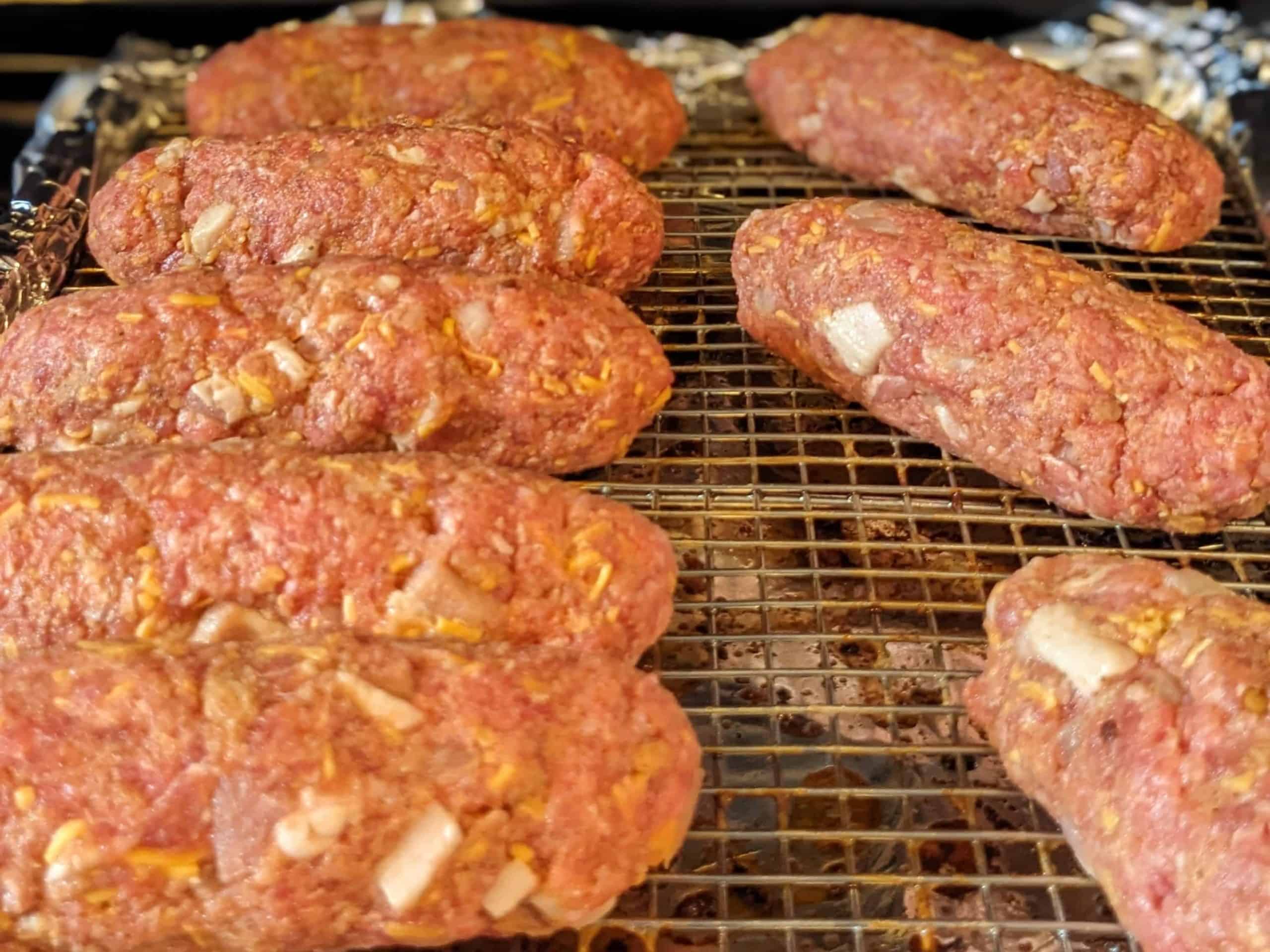 Uncooked personal-size meatloaves on a rack