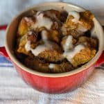 Low Carb Pumpkin Bread Pudding with a glaze in a red croquette