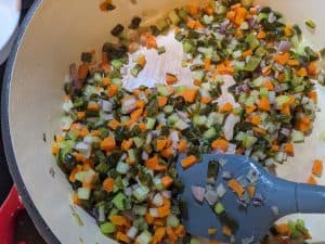 Sauteing onions, carrots, celery, and roasted poblanos in a Dutch oven