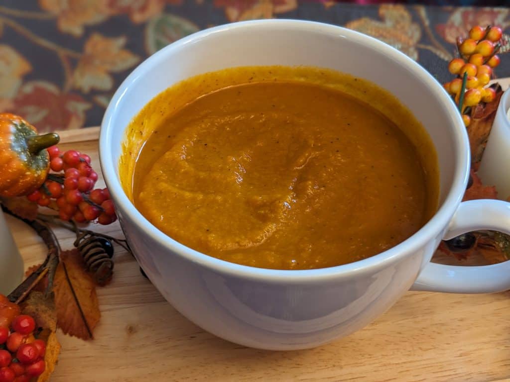 Close up of Savory Pumpkin Soup in a white cup / bowl