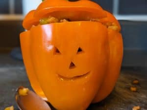 Orange Bell Pepper Stuffed and carved to look like a Jack-O-Lantern