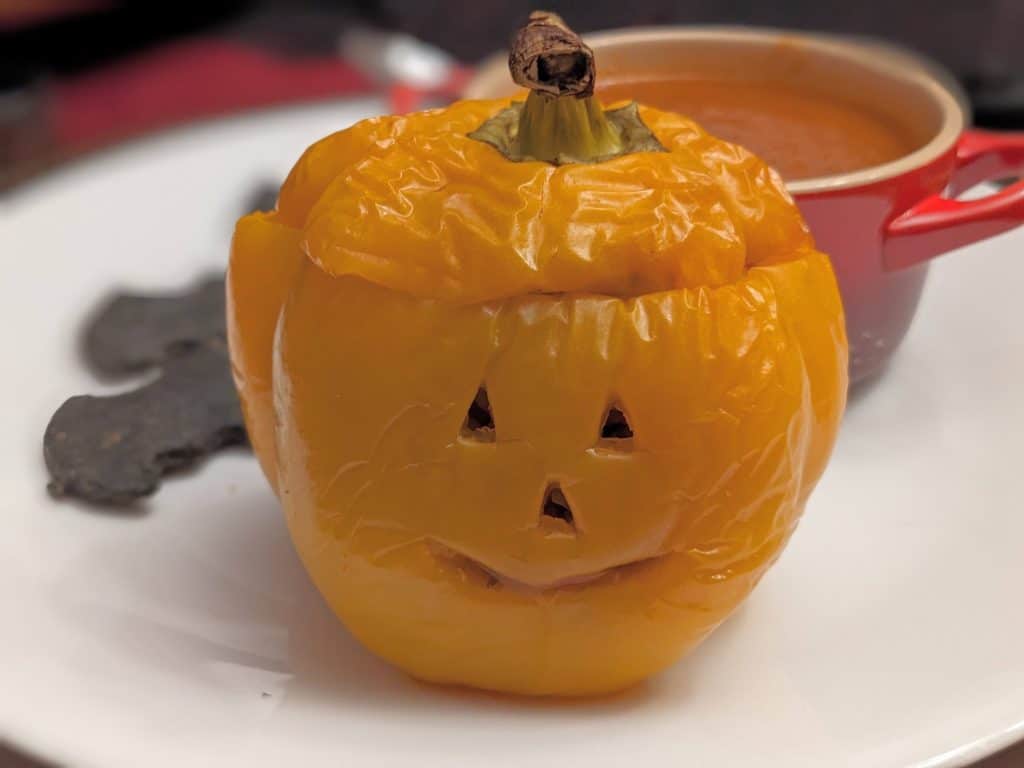 Stuffed Orange Bell Pepper carved to look like a Jack-O-Lantern