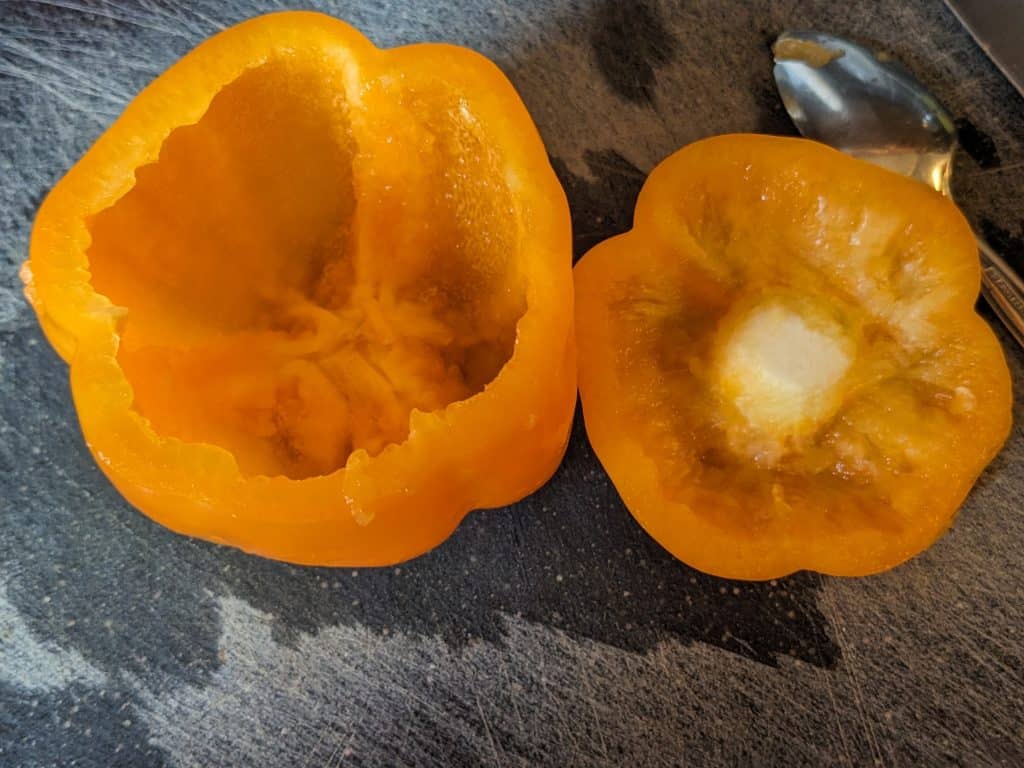 Orange bell pepper with the top sliced off and the seeds and membranes removed