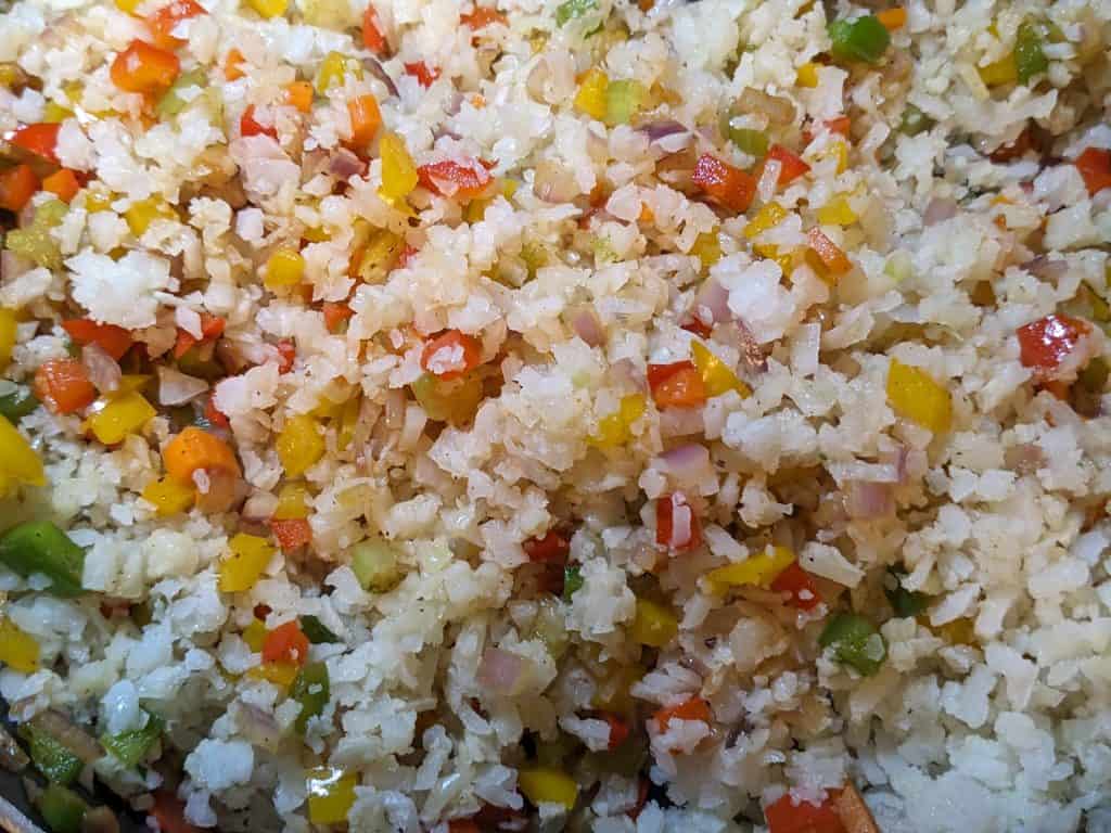 Stuffing mix of cauliflower rice, peppers, onions, carrots, and celery for Stuffed Peppers