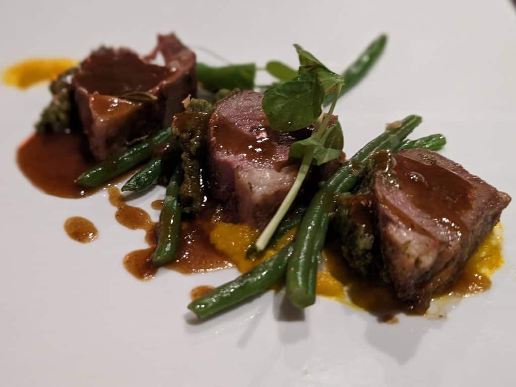 Fennel-Crusted Grilled Lamb Loin with Carrot Purée, Haricots Verts, and Natural Jus