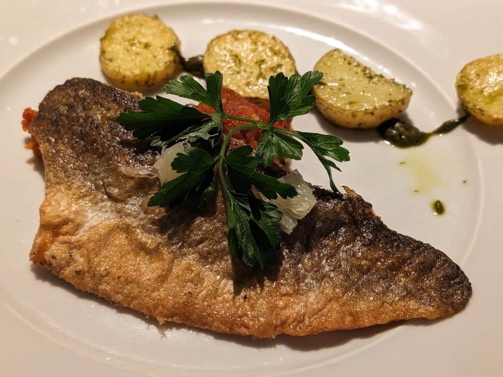 Seared Branzino with Eggplant Caponata, Lemon Confit, Basil Vinaigrette