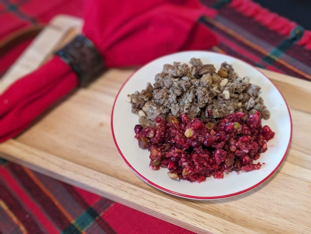 Cranberry Pomegranate Relish on a plate alongside Greek Stuffing