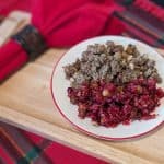 Cranberry Pomegranate Relish on a plate alongside Greek Stuffing