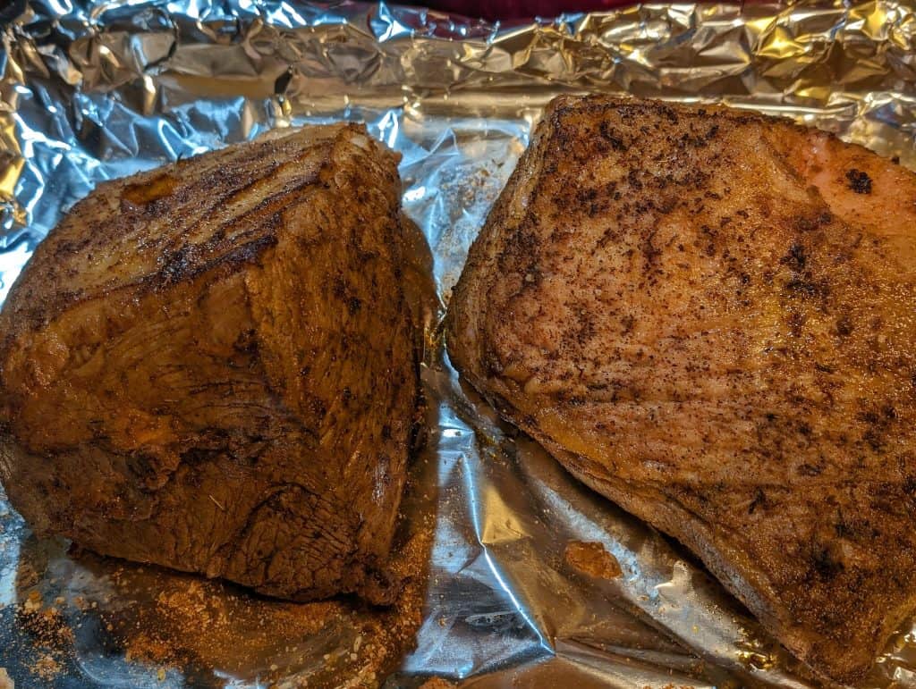 Two beef roasts that have been seasoned and seared