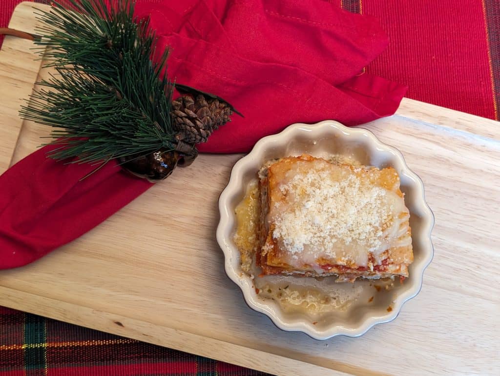 Overhead view of a slice of Easy Low Carb Lasagna in a ceramic dish