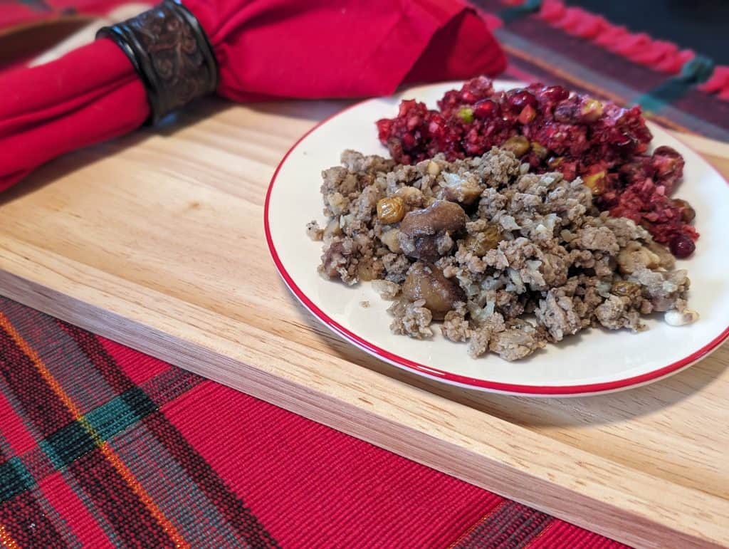 Greek Stuffing on a plate alongside Cranberry Pomegranate Relish